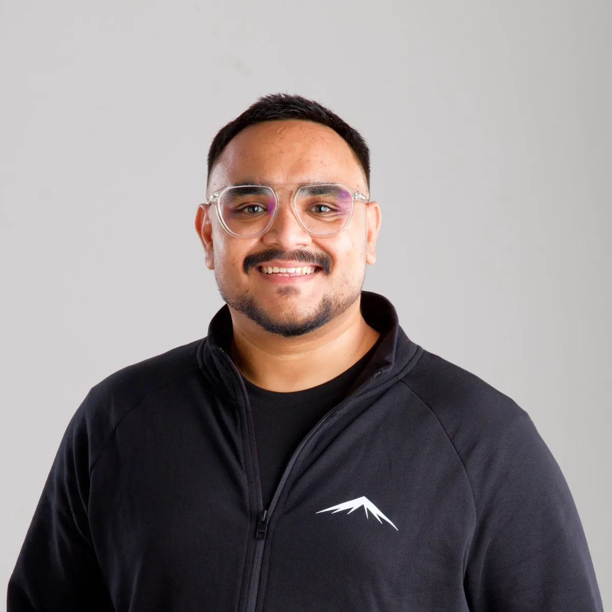 Arnob, smiling, in the Lumenridge jacket