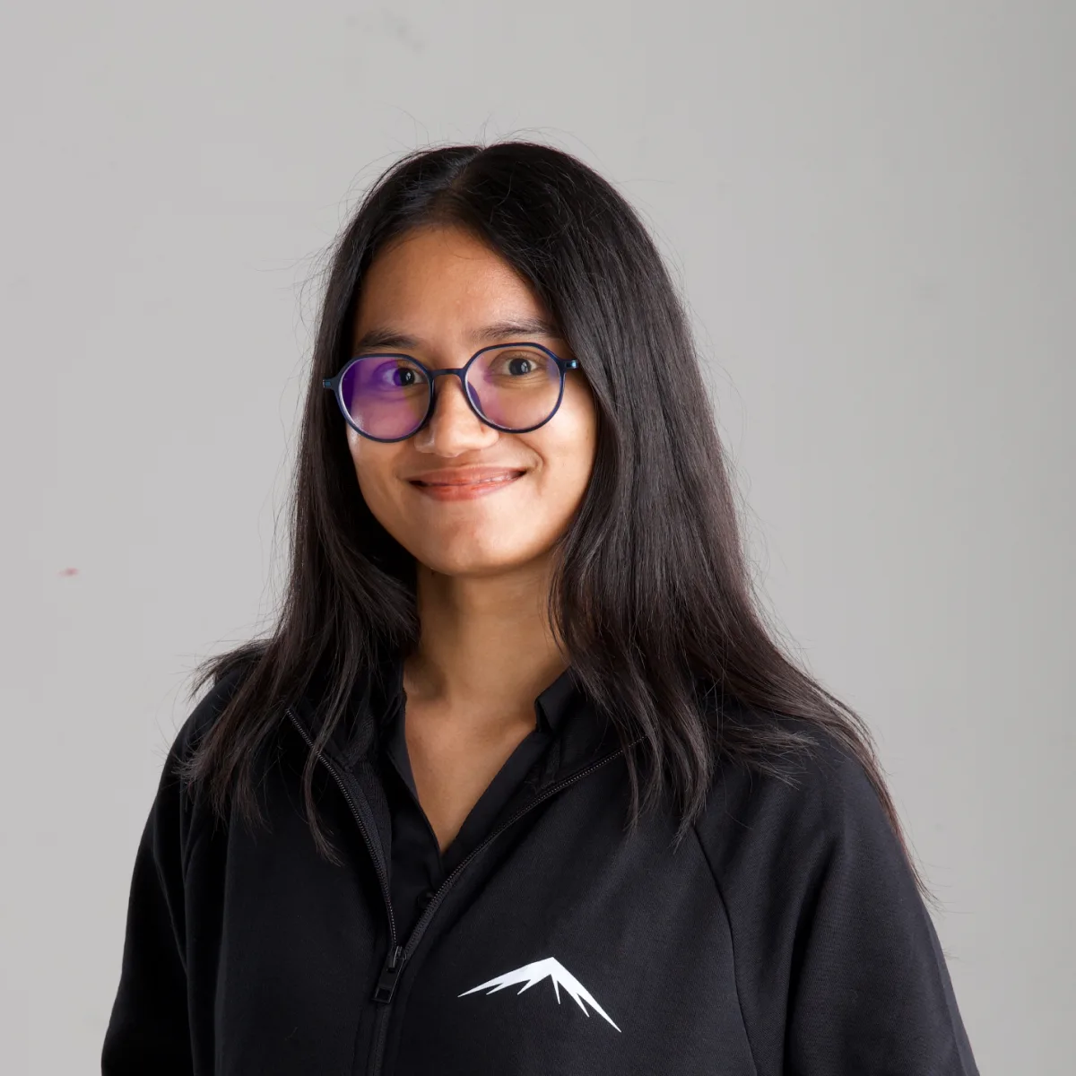 Chetna, smiling, in the Lumenridge jacket