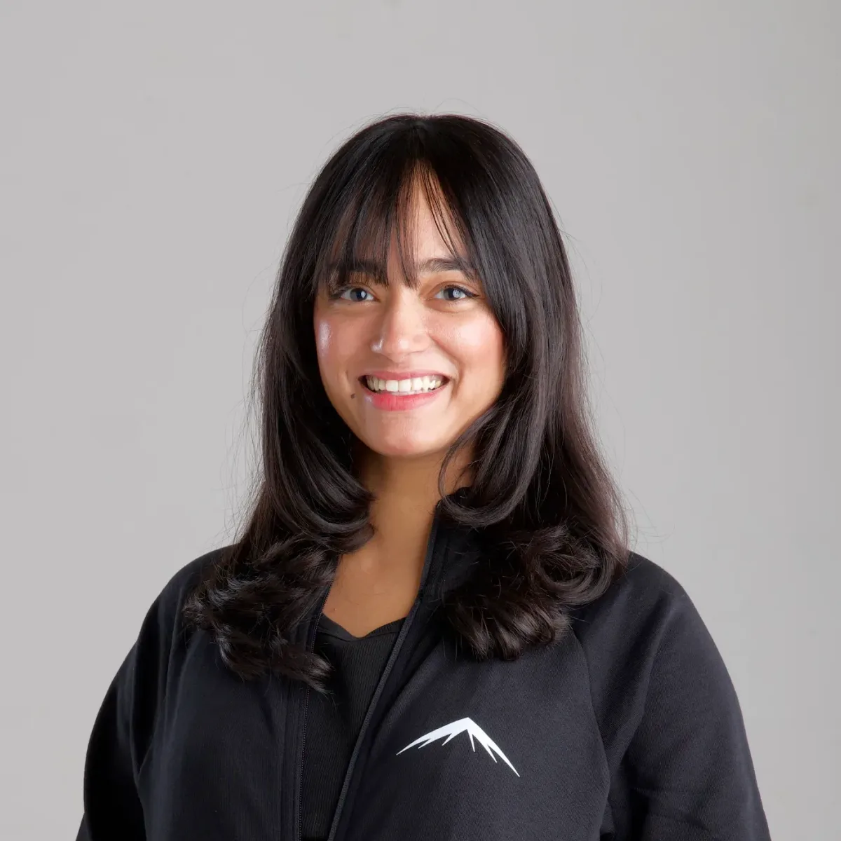 Elaiza, smiling, in the Lumenridge jacket