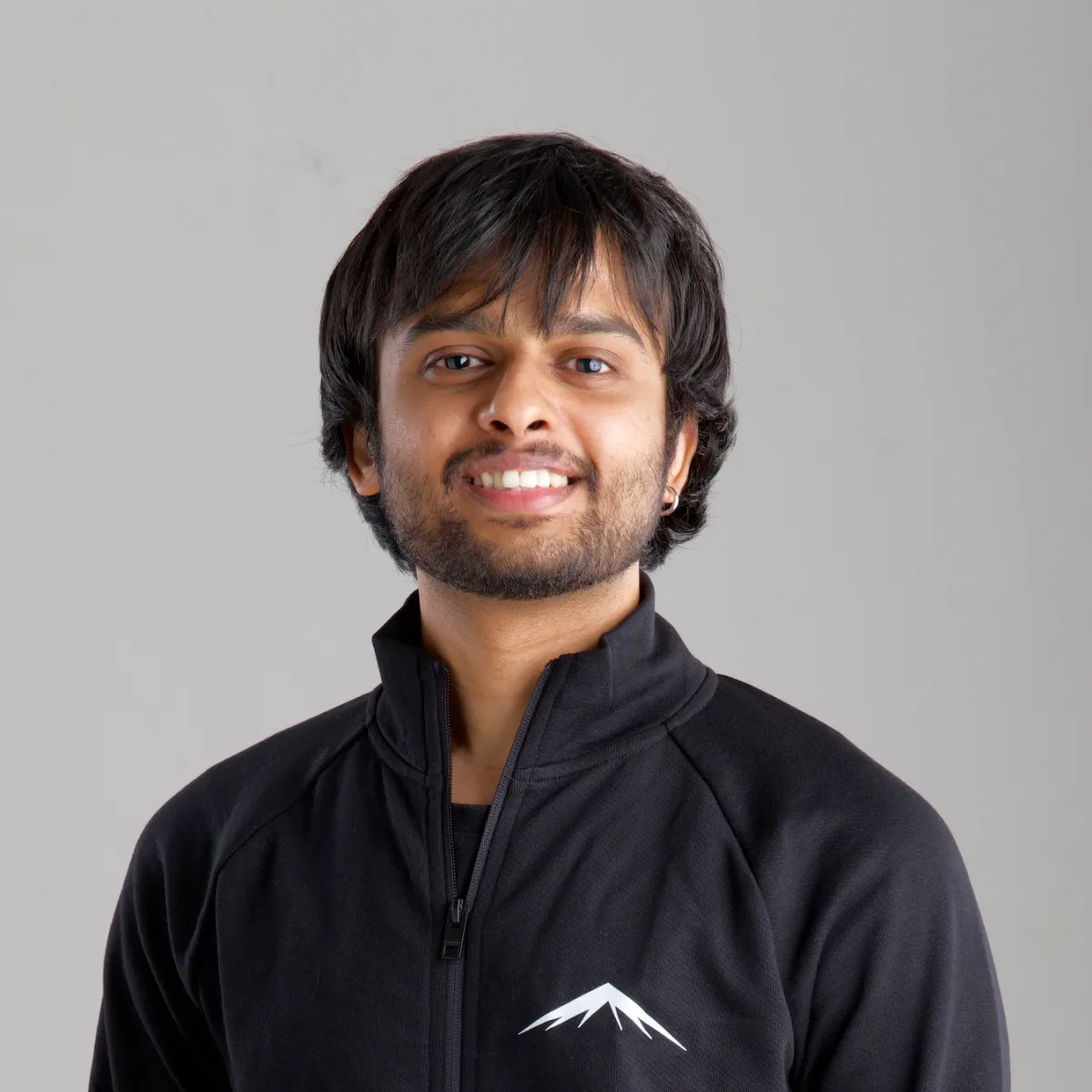 Meet, smiling, in the Lumenridge jacket