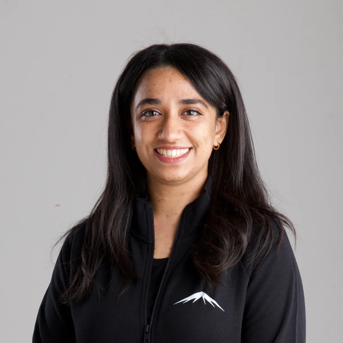 Saima, smiling, in the Lumenridge jacket